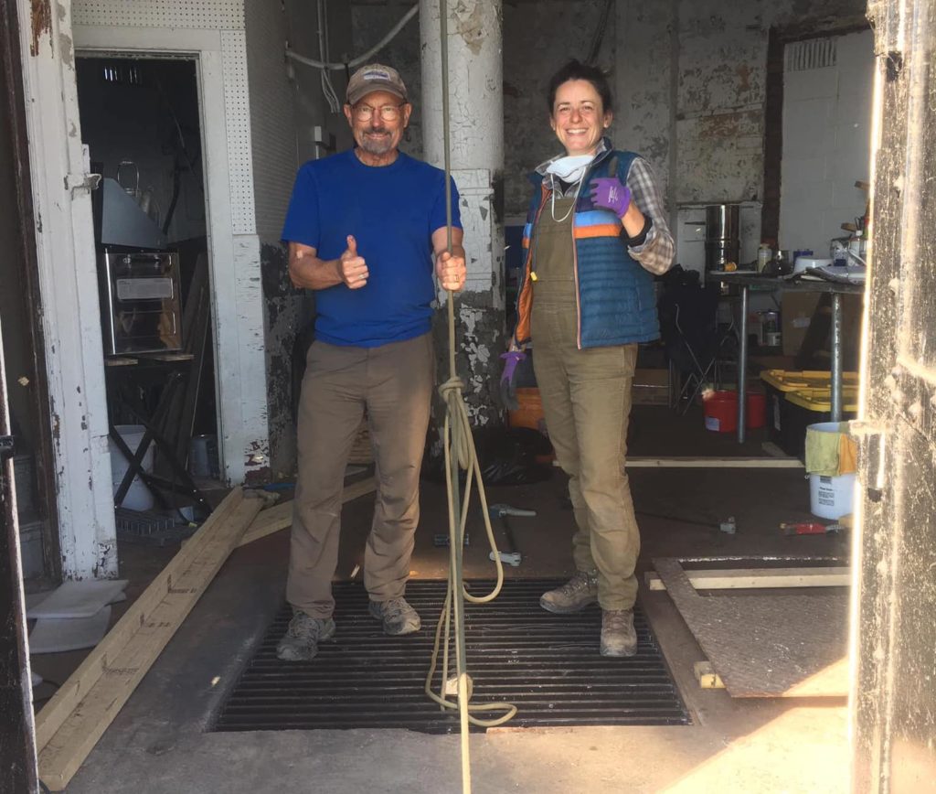 Volunteers giving the thumbs up after testing the grate in the engine room.