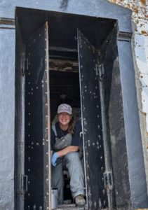 Volunteer looking through a newly painted window.